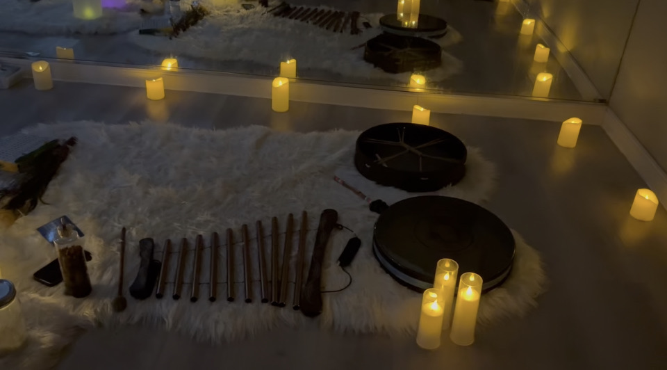 Candles and sound-healing instruments set for a sound bath