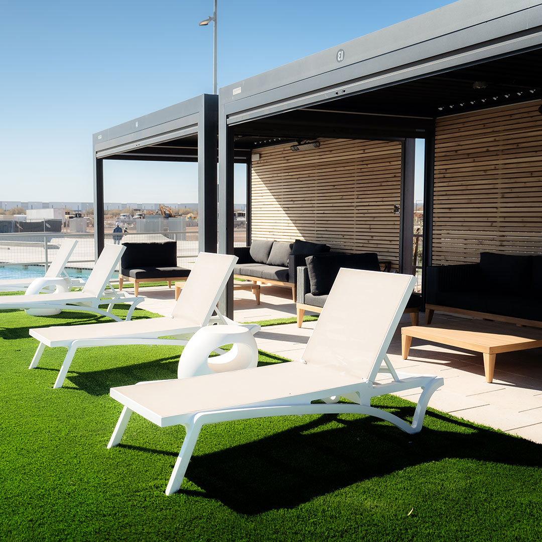 Shaded cabanas and daybeds on the grass